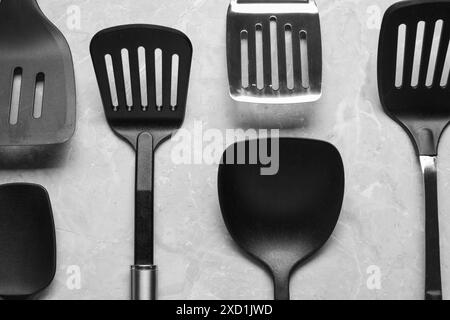 Different spatulas on grey marble table, flat lay Stock Photo