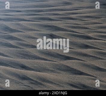 Geometrical patters in the sand caused by sand and wind. Stock Photo