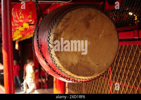 A large traditional drum made of wood and ox or buffalo skin hangs in ...