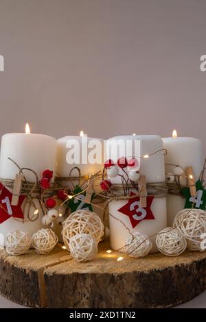 Four Advent candles calendar with Christmas zero waste decorations. Holiday preparation copy space for text. Catholic traditions of Christmas countdown new year winter holidays  Stock Photo