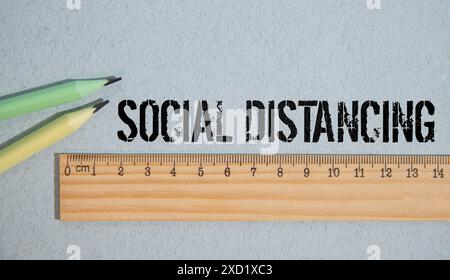 Social distancing text in a colored paper Stock Photo