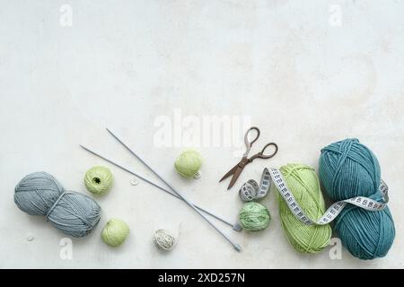 Yarn balls, knitting needles and measuring tape on white background Stock Photo
