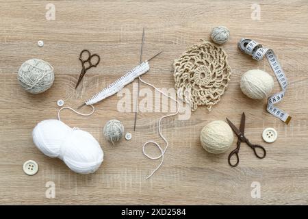 Yarn balls, scissors and knitting accessories on wooden background Stock Photo