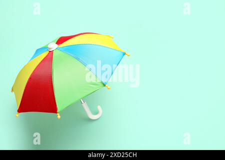 Mini colorful umbrella on green background Stock Photo