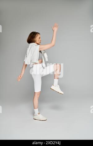 Mature woman poses actively in tan blazer and pants on chair Stock ...