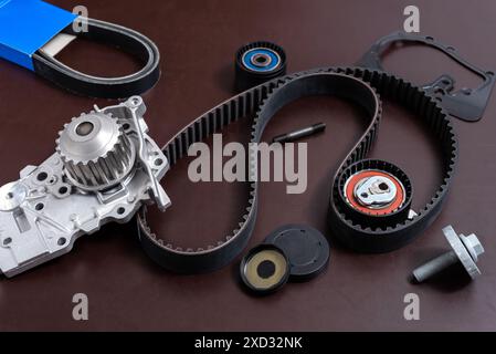 Spare parts for the car. The set of timing belt with rollers and cooling pump on a working table. Stock Photo