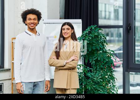 Two professionals discussing a project in a modern office setting. Stock Photo