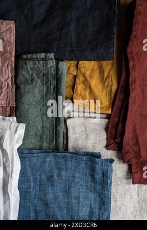 Top view of an array of textile napkins in various colors neatly arranged in a flat lay composition, exhibiting a spectrum from white to black with hu Stock Photo