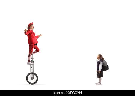 Surprised girl watching an acrobat riding a giraffe unicycle isolated on white background Stock Photo