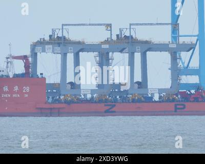 Sheerness, Kent, UK. 20th June, 2024. Ship Zhen Hua 28 seen carrying four cranes from Shanghai, China as it arrived on the Thames this morning - pictured from Sheerness, Kent. Two of the cranes are being delivered to London Gateway. Credit: James Bell/Alamy Live News Stock Photo