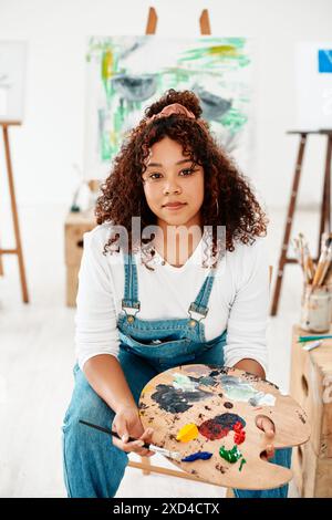 Art, painting and woman portrait at easel, palette and apprentice for creative project. Female person, painter and artist for crafts on canvas Stock Photo