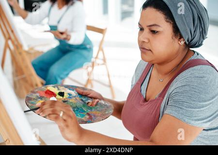 People, woman and creativity with paint, talent and hobby with ideas, stress relief and activity. Relax, girl and painter with palette, thinking and Stock Photo