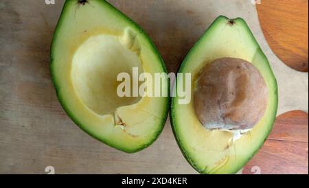 A photo of an avocado that has been split on a table Stock Photo