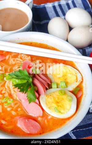 Photo of noodle soup with toppings such as sausages, eggs, and vegetables Stock Photo