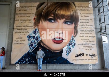 London, UK.  20 June 2024.  Taylor Swift fans ('Swifties') at the 'Swiftie Steps' by a mural by Humor Street Art of the singer outside Wembley Stadium ahead of Taylor Swift’s Eras Tour concerts.  Taylor Swift will perform at Wembley Stadium for three nights in June (beginning 21 June) and then five nights in August. Credit: Stephen Chung / Alamy Live News Stock Photo