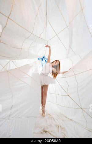 Ballerina Dancing Under a White Canopy During the Day Stock Photo