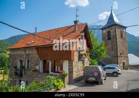 House and tower of the church. San Juan de Plan, Huesca province, Aragon, Spain. Stock Photo