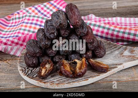 Large size Jerusalem Date fruit. Close up shot of date fruit on marble tray in silver bowl on wooden table background. Dried date fruit is healthy as Stock Photo