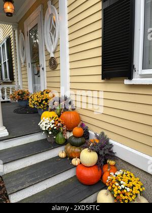 Pumpkins, gourds and autumn decorations are placed on the stairway of a house in Salem Massachusetts in the days leading up to Halloween Stock Photo