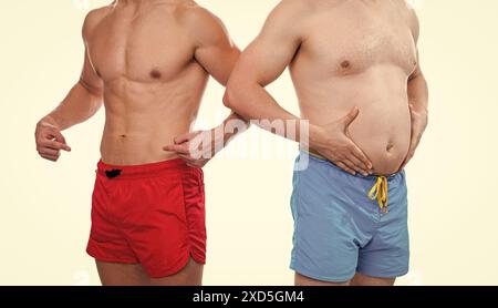 cropped view of men showing belly abs comparison. photo of men with belly abs comparison Stock Photo