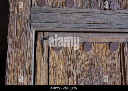 Close up ancient mesquite timber door with iron fasteners Stock Photo