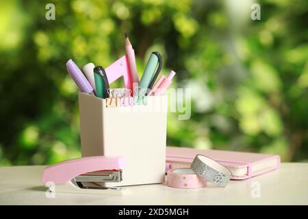 Stapler, holder and other different stationery on white table Stock Photo