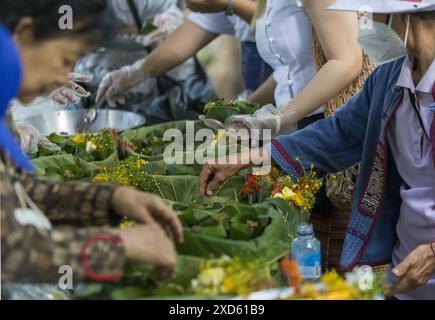 Chiang Mai, Thailand. 20th June, 2024. Thai people prepare offerings during the festival. The festival is unique and not often witnessed by outsiders, but held annually in the foothills of Doi Kham Mountain, to pay homage to two ancient giant spirits, Pu Sae and Ya Sae. Credit: SOPA Images Limited/Alamy Live News Stock Photo