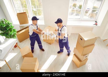 Two Movers Delivering Boxes at Home or Office Stock Photo