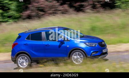 Milton Keynes,UK - June 20th 2024: 2017 blue Vauxhall Mokka car driving on a British country road Stock Photo