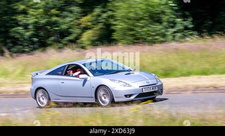 Milton Keynes,UK - June 20th 2024: 2005 Toyota Celica classic  car driving on a British country road Stock Photo