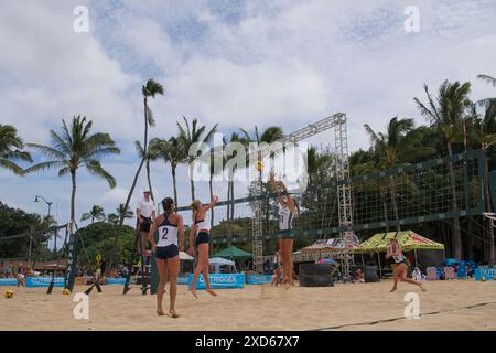 Womens beach volley ball in action.  Players attacking, ball in view Stock Photo