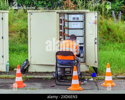 Technician working with wiring in electrical distribution box - Tours, Indre-et-Loire (37), France. Stock Photo