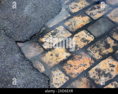 broken road surface revealing older granite setts - Tours, Indre-et-Loire (37), France. Stock Photo