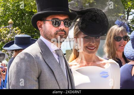 Ascot, Berkshire, UK. 20th June, 2024. Singer Katherine Jenkins and partner Andrew Levitas. Racegoers on Ladies Day (Day 3) of Royal Ascot. Dapper gentlemen in formal attire and ladies, often in dresses and elaborate hat creations can be seen arriving and mingling before going to the races. Credit: Imageplotter/Alamy Live News Stock Photo