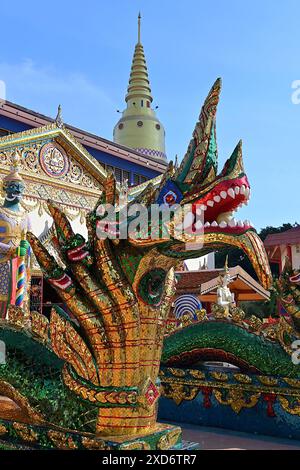 Large ornate Naga sculpture with multiple heads, guarding entrance to prayer hall of Wat Chayamangkalaram, oldest Siamese Buddhist temple in Penang Stock Photo