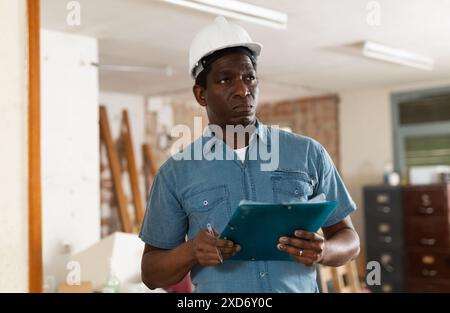Responsible engineer with papers conducting inspection of construction site Stock Photo