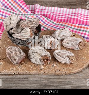 Sweet appetizing healthy persimmon dried. Dried persimmon fruit sold by the herbalist. Known name in Turkish: Cennet Hurmasi. Stock Photo