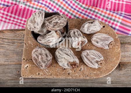 Sweet appetizing healthy persimmon dried. Dried persimmon fruit sold by the herbalist. Known name in Turkish: Cennet Hurmasi. Stock Photo