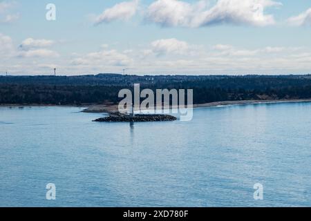 Maugher Beach lighthouse on McNabs Island from York Redoubt National Historic Site in Fergusons Cove, Nova Scotia, Canada Stock Photo