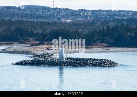 Maugher Beach lighthouse on McNabs Island from York Redoubt National Historic Site in Fergusons Cove, Nova Scotia, Canada Stock Photo