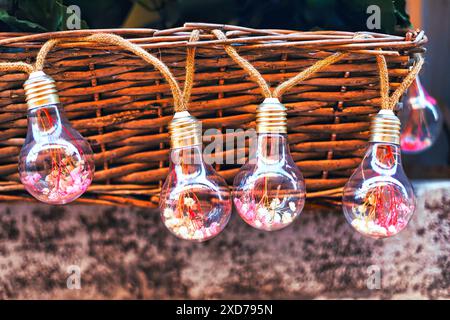 Light bulbs in a wicker basket on a background of the wall. Charming and illuminated atmosphere Stock Photo