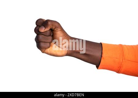 Fisted hand in orange sweater giving a punch, fist over white background Stock Photo