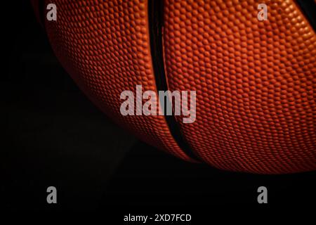 Closeup orange basketball surface on the black. Professional sports backgrounds Stock Photo