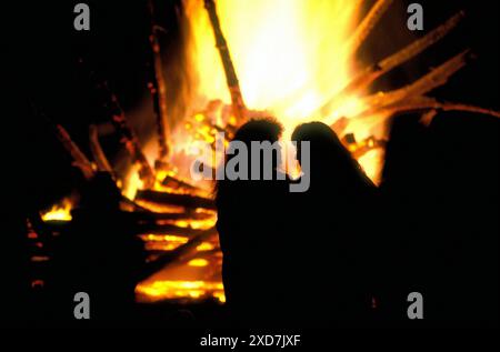 People at a outdoor wood fire Stock Photo