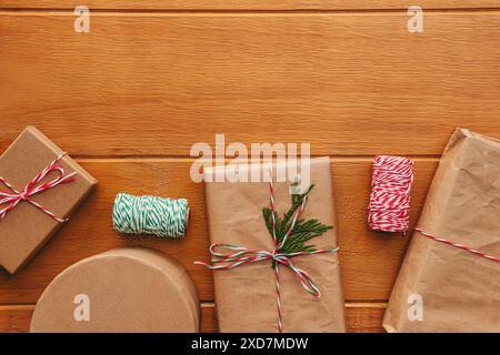 Gift boxes wrapped in craft paper on wooden table, Christmas presents, top view Stock Photo