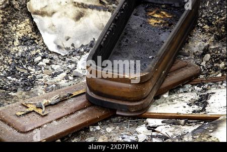 Burnt coffin wit0h flowers in cemetery, religion and burial Stock Photo