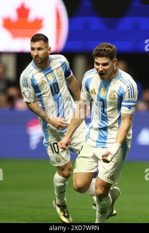 Argentina's forward Julian Alvarez (R) celebrates with his teammate forward Lionel Messi after scoring the team’s first goal against Canada during the Copa America USA 2024, group A, groupe stage match between Argentina and Canada, at Mercedes Benz stadium in Atlanta, on June 20, 2024. Stock Photo