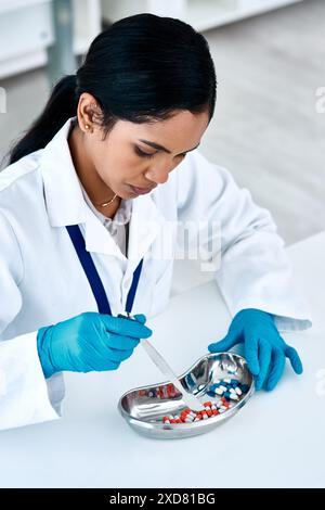 Hospital, pharmacist or woman for counting tablets, pills and supplements on stainless tray. Pharmacy, female employee and medicine for sorting Stock Photo