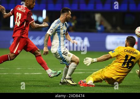 Argentina's forward Lionel Messi (C) vies for the ball with Canada’s goalkeeper Maxime Crepeau during the Copa America USA 2024, group A, groupe stage match between Argentina and Canada, at Mercedes Benz stadium in Atlanta, on June 20, 2024. Stock Photo