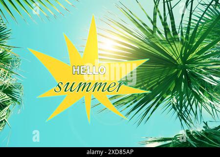 Hello Summer text against palms and bright sky on sunny day Stock Photo